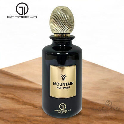 Mountain Nuit Paris 100ml EDP by Grandeur Elite bottle on table lifestyle image